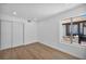 Bright bedroom with sliding closet doors, wood-look floors, and a large window at 6939 Paddington Way, Las Vegas, NV 89147