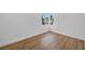 Sunlit bedroom with wood-look flooring, white walls, and a bright window at 6939 Paddington Way, Las Vegas, NV 89147