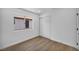 Clean bedroom featuring wood-look flooring, white walls, and mirrored closet doors at 6939 Paddington Way, Las Vegas, NV 89147
