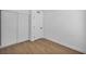 Bright bedroom with wood-look floors and a white paneled door at 6939 Paddington Way, Las Vegas, NV 89147