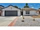 Charming single-story home with a well-maintained, low-water landscaped front yard and two-car garage at 6939 Paddington Way, Las Vegas, NV 89147