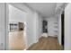 Hallway featuring an open living space with fireplace and a utility closet with shelves at 6939 Paddington Way, Las Vegas, NV 89147