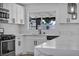 Bright kitchen featuring white cabinets, stainless steel appliances and marble countertops at 6939 Paddington Way, Las Vegas, NV 89147