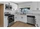 Updated kitchen features stainless appliances and stone countertops at 6939 Paddington Way, Las Vegas, NV 89147