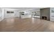 Expansive living space connects the kitchen with fireplace and backyard access, offering a seamless flow at 6939 Paddington Way, Las Vegas, NV 89147