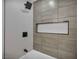Modern shower featuring gray tile, built-in niche, and matte black fixtures at 6939 Paddington Way, Las Vegas, NV 89147