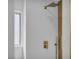 Modern shower with gold fixtures, white tile and a glass shower door at 6939 Paddington Way, Las Vegas, NV 89147