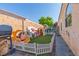 Fully fenced backyard with artificial grass, play area and barbecue grill at 7697 Morning Lake Dr, Las Vegas, NV 89131