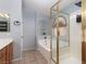 Bright bathroom with a tiled shower, soaking tub, and stylish fixtures at 7697 Morning Lake Dr, Las Vegas, NV 89131