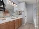 Well-lit bathroom features a double vanity, large mirrors, and separate tub and shower at 7697 Morning Lake Dr, Las Vegas, NV 89131
