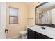 Clean bathroom with black cabinets, decorative shower curtain and blind-covered window at 7697 Morning Lake Dr, Las Vegas, NV 89131