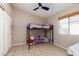Well-lit bedroom featuring bunk beds, a ceiling fan and tiled flooring throughout at 7697 Morning Lake Dr, Las Vegas, NV 89131