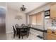 Cozy dining area with a black round table, bench seating, and decorative wall art at 7697 Morning Lake Dr, Las Vegas, NV 89131