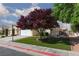 Lovely home with well-maintained lawn and mature tree in front at 7697 Morning Lake Dr, Las Vegas, NV 89131