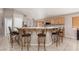Kitchen bar with seating and a view of the stainless steel refrigerator at 7697 Morning Lake Dr, Las Vegas, NV 89131