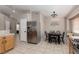 Bright kitchen area featuring stainless steel appliances and a dining nook with decorative lighting at 7697 Morning Lake Dr, Las Vegas, NV 89131