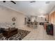 Open-concept living area with tiled flooring and a breakfast bar with seating at 7697 Morning Lake Dr, Las Vegas, NV 89131