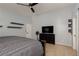 Comfortable main bedroom with a ceiling fan, dresser, and neutral decor at 7697 Morning Lake Dr, Las Vegas, NV 89131