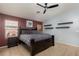 Bright main bedroom features a ceiling fan, large bed, and accent walls at 7697 Morning Lake Dr, Las Vegas, NV 89131