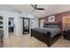 Spacious main bedroom with a large bed, barn door to bathroom, and walk-in closet at 7697 Morning Lake Dr, Las Vegas, NV 89131