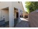 Outdoor patio area with neutral walls, accent curtains and privacy wall at 7697 Morning Lake Dr, Las Vegas, NV 89131