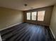 Bedroom with wood-look floors, neutral walls, three windows offering plenty of natural light at 7929 Valladolid Ave, Las Vegas, NV 89178