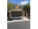 Inviting two-story home featuring a neutral color scheme, attached two-car garage, and well-maintained landscaping at 7929 Valladolid Ave, Las Vegas, NV 89178