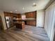 Bright kitchen featuring wood cabinetry, stainless steel appliances, granite countertops, island, and ample natural light at 7929 Valladolid Ave, Las Vegas, NV 89178