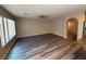 Open living area with wood-look floors, ceiling fan, and seamless flow into the kitchen at 7929 Valladolid Ave, Las Vegas, NV 89178