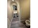 Cozy powder room with pedestal sink, toilet, and wood-look flooring, perfect for guests at 7929 Valladolid Ave, Las Vegas, NV 89178