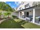 Backyard featuring a patio with modern outdoor furniture and artificial grass at 7984 Laurena Ave, Las Vegas, NV 89147