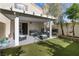Inviting outdoor seating on covered patio with artificial grass and well maintained landscaping at 7984 Laurena Ave, Las Vegas, NV 89147