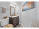 Bathroom with a modern vanity, toilet, and decorative accents at 7984 Laurena Ave, Las Vegas, NV 89147