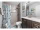 Clean bathroom featuring a shower and sink with dark wood cabinets at 7984 Laurena Ave, Las Vegas, NV 89147