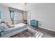 Bedroom featuring a light blue cabinet and sunny window with plantation shutters at 7984 Laurena Ave, Las Vegas, NV 89147