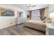 Bright bedroom with wood floors, a ceiling fan, and neutral decor at 7984 Laurena Ave, Las Vegas, NV 89147