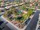 Aerial view showcases the community pool, lush trees and well-maintained homes in the neighborhood at 7984 Laurena Ave, Las Vegas, NV 89147