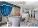 Dining area featuring an elegant table set, a chandelier, and adjacent kitchen view at 7984 Laurena Ave, Las Vegas, NV 89147