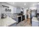 Well-lit kitchen with gray cabinets, modern appliances, granite countertops, and a tiled backsplash at 7984 Laurena Ave, Las Vegas, NV 89147