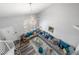 Bright living room with a chandelier, staircase, and open layout at 7984 Laurena Ave, Las Vegas, NV 89147