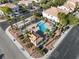 Aerial shot of the community pool with uniquely designed shape, cabana and surrounding palm trees at 7984 Laurena Ave, Las Vegas, NV 89147
