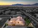 An elevated shot displays a cozy house with an inviting patio and a quaint putting green at 8126 Majestic Bighorn St, Las Vegas, NV 89166