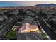 An elevated view captures a home with a putting green amidst a neighborhood backdrop at 8126 Majestic Bighorn St, Las Vegas, NV 89166