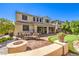 Expansive backyard with a patio, fire pit, putting green, and comfortable seating at 8126 Majestic Bighorn St, Las Vegas, NV 89166