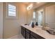 Bathroom featuring a double sink vanity, modern lighting, and a large mirror at 8126 Majestic Bighorn St, Las Vegas, NV 89166