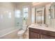 Clean bathroom features a shower over tub and white sink with dark wood cabinets at 8126 Majestic Bighorn St, Las Vegas, NV 89166