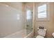 Clean bathroom with a shower-tub, toilet, and shuttered window for natural light at 8126 Majestic Bighorn St, Las Vegas, NV 89166