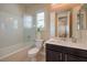 Bathroom with a single sink vanity, a combined shower and tub, and shuttered windows at 8126 Majestic Bighorn St, Las Vegas, NV 89166
