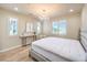 Bright bedroom with a crystal chandelier, a queen sized bed, and plantation shutters at 8126 Majestic Bighorn St, Las Vegas, NV 89166