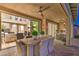 Inviting covered patio with a ceiling fan, dining table, and an open view to the home's interior at 8126 Majestic Bighorn St, Las Vegas, NV 89166
